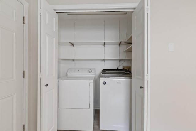 washroom featuring laundry area and washer and clothes dryer