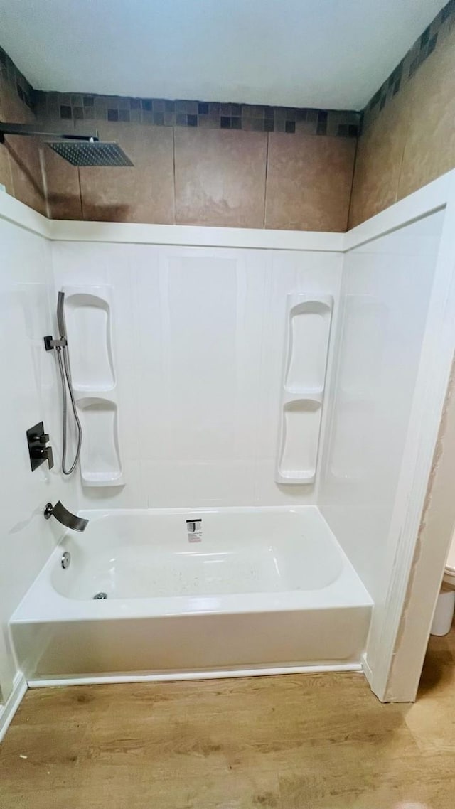 bathroom featuring shower / bath combination and wood finished floors