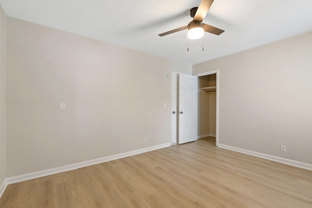 empty room with light wood-type flooring, ceiling fan, and baseboards