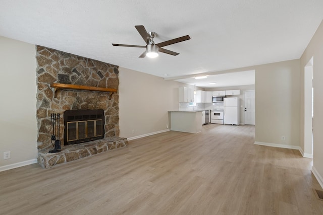 unfurnished living room featuring light wood finished floors, a fireplace, and baseboards