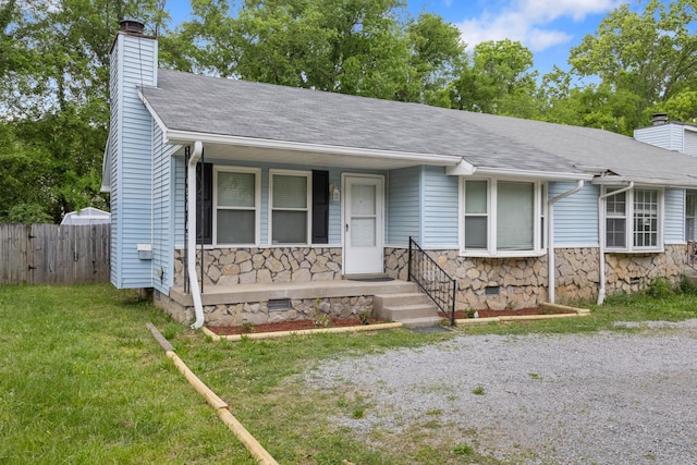 view of front of house with crawl space, stone siding, a chimney, and fence