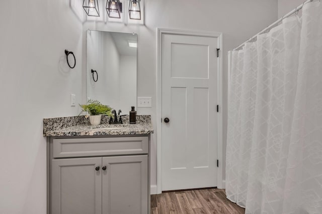 full bathroom with wood finished floors and vanity