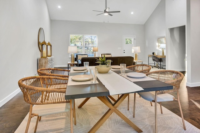 dining room featuring baseboards, ceiling fan, wood finished floors, high vaulted ceiling, and recessed lighting