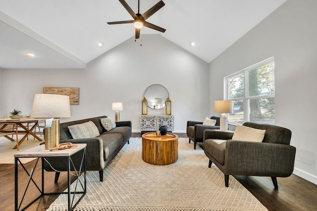 living area with baseboards, high vaulted ceiling, and wood finished floors