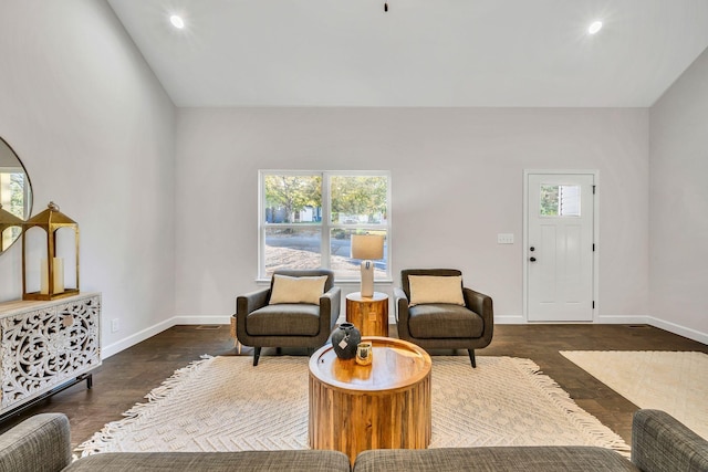 living area featuring vaulted ceiling, recessed lighting, wood finished floors, and baseboards