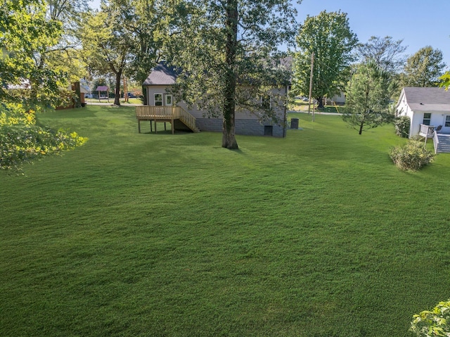 view of yard with a wooden deck and stairs