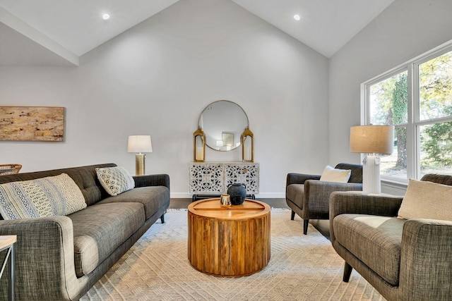 living room with high vaulted ceiling, recessed lighting, light wood-style flooring, and baseboards