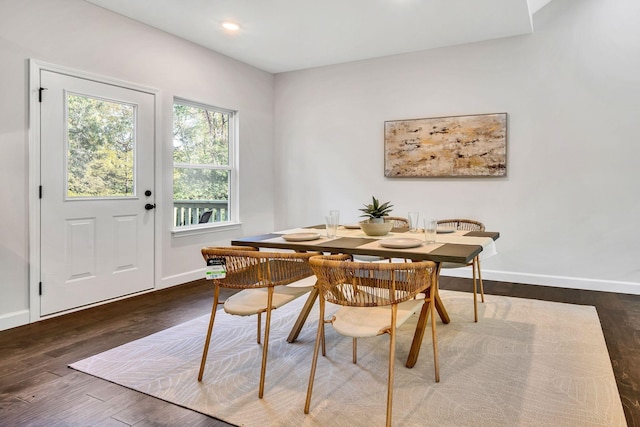 dining space with baseboards, wood finished floors, and recessed lighting