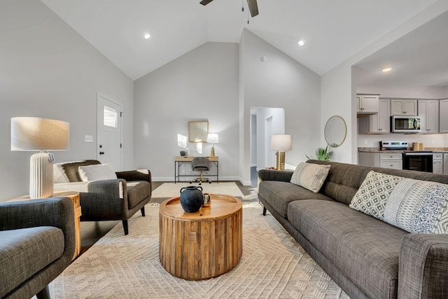 living area with high vaulted ceiling, recessed lighting, a ceiling fan, and baseboards