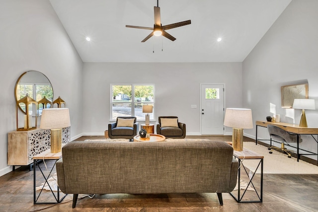 living area with high vaulted ceiling, ceiling fan, baseboards, and wood finished floors