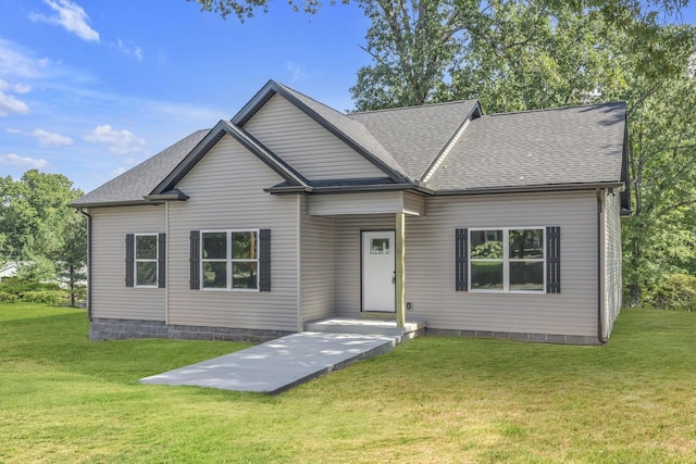 view of front of property with a front yard and roof with shingles