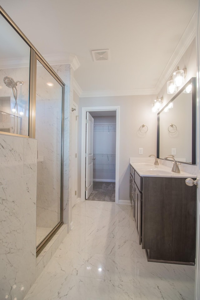 bathroom with a marble finish shower, ornamental molding, marble finish floor, a walk in closet, and vanity