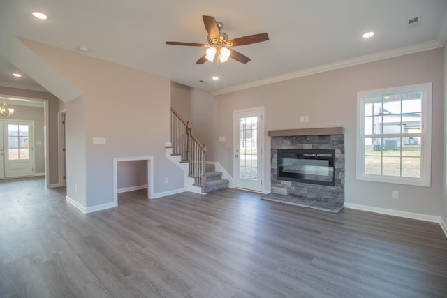 unfurnished living room with baseboards, stairway, and wood finished floors