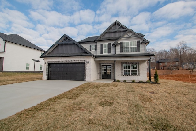 craftsman-style home featuring driveway, an attached garage, a front lawn, board and batten siding, and brick siding