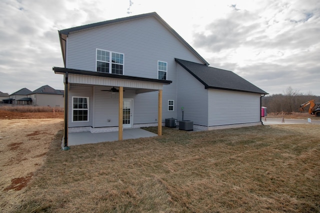 rear view of property with a patio area, ceiling fan, a lawn, and central air condition unit