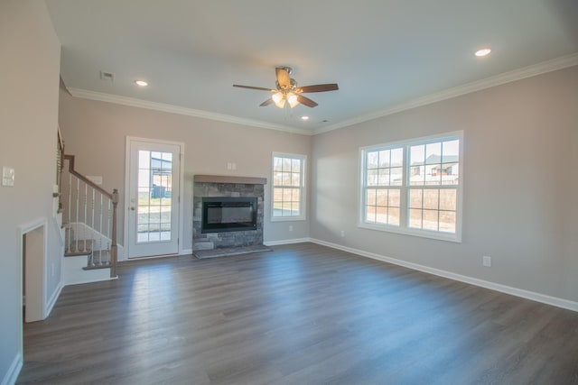 unfurnished living room with a fireplace, baseboards, ornamental molding, stairway, and dark wood finished floors