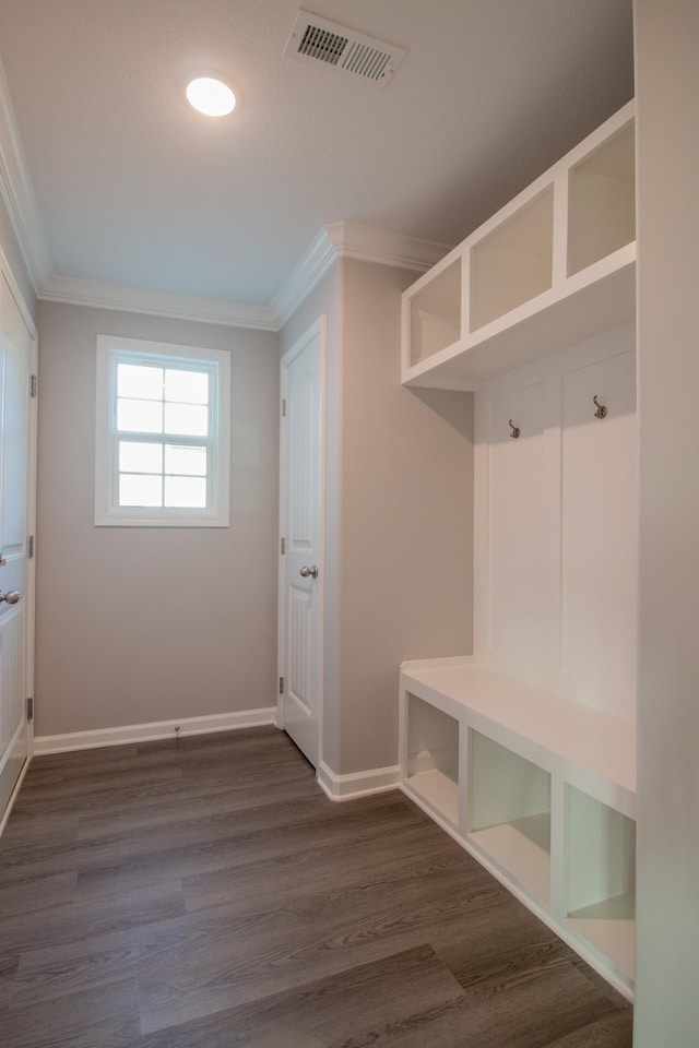 mudroom with baseboards, dark wood finished floors, visible vents, and crown molding