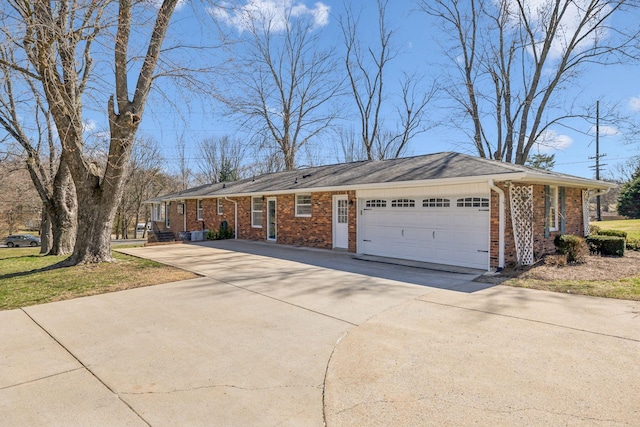 ranch-style home with concrete driveway, brick siding, and an attached garage