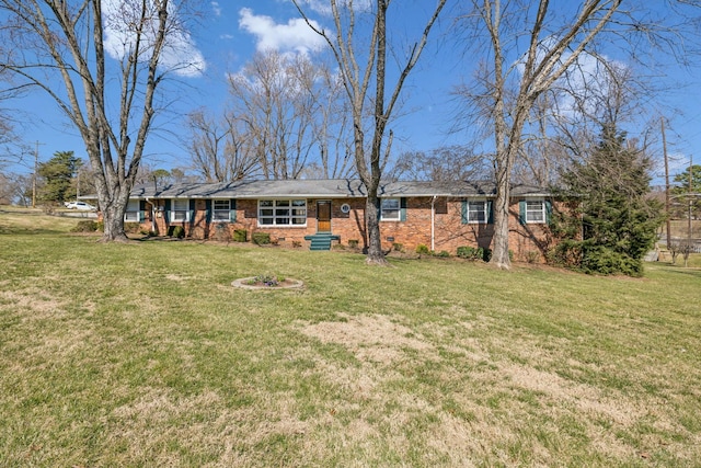 view of front facade with a front lawn and brick siding