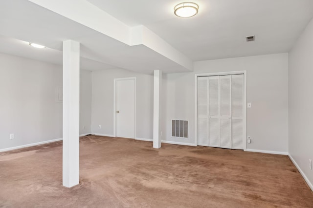 finished basement featuring carpet, visible vents, and baseboards