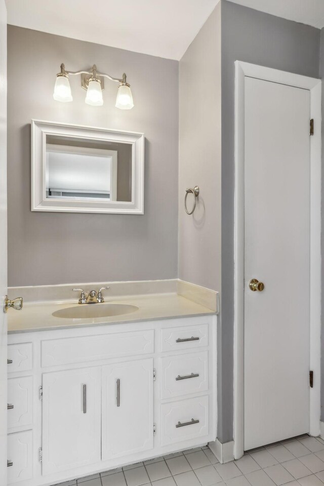 bathroom with tile patterned flooring and vanity