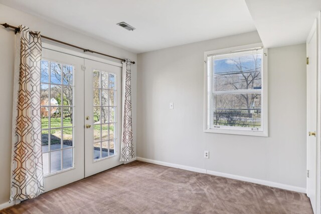 entryway with carpet floors, french doors, a healthy amount of sunlight, and visible vents