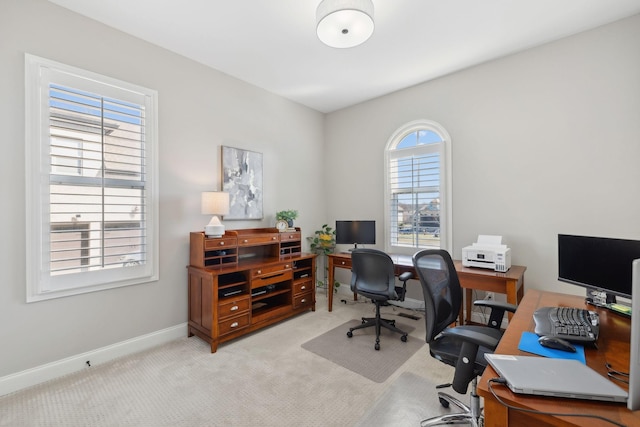 office space featuring baseboards and light colored carpet