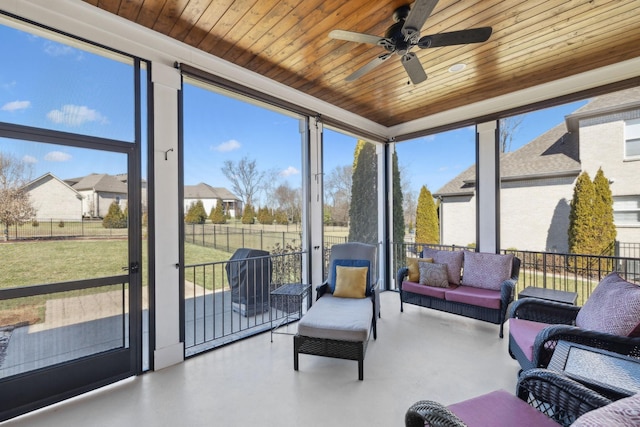 sunroom / solarium with wooden ceiling and a ceiling fan