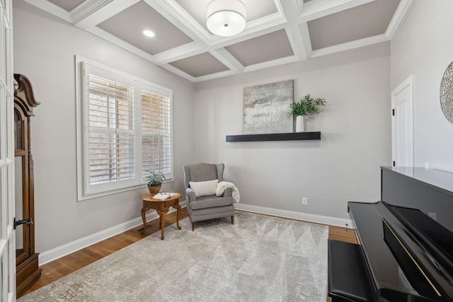 sitting room featuring coffered ceiling, baseboards, and wood finished floors