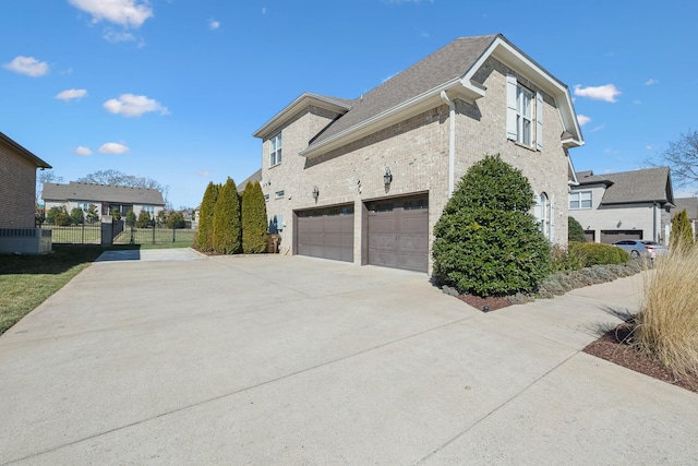 view of home's exterior featuring brick siding, central AC unit, fence, a garage, and driveway