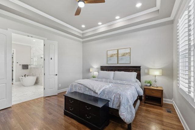 bedroom featuring baseboards, visible vents, wood finished floors, and ornamental molding