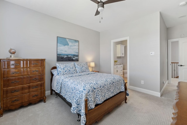 bedroom with a ceiling fan, baseboards, connected bathroom, and light colored carpet