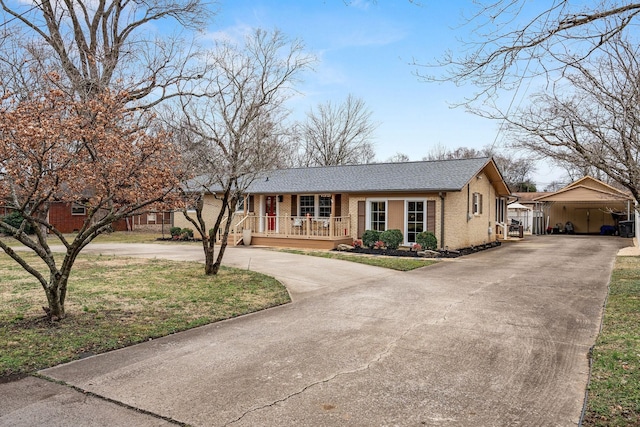 ranch-style home with covered porch, brick siding, and roof with shingles