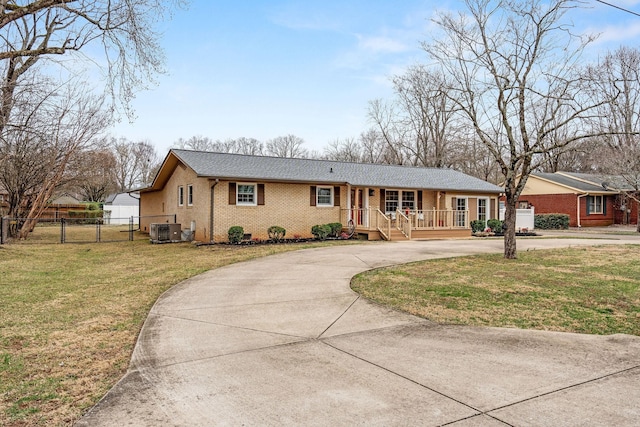 ranch-style house with central air condition unit, brick siding, fence, driveway, and a front yard