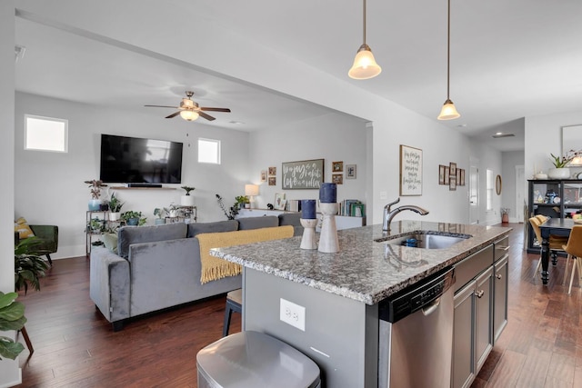 kitchen with a sink, dark wood-type flooring, open floor plan, and stainless steel dishwasher