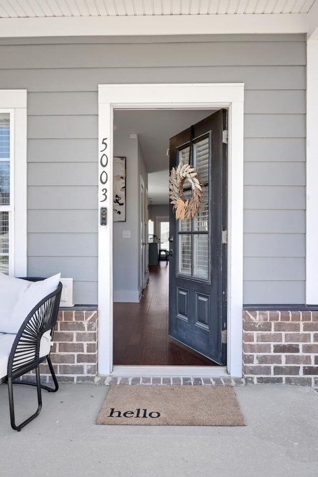 view of exterior entry with covered porch