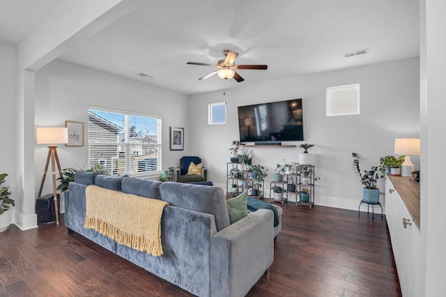 living room with ceiling fan, visible vents, and hardwood / wood-style floors