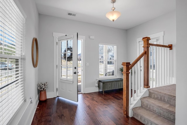 entryway featuring stairs, wood finished floors, visible vents, and baseboards