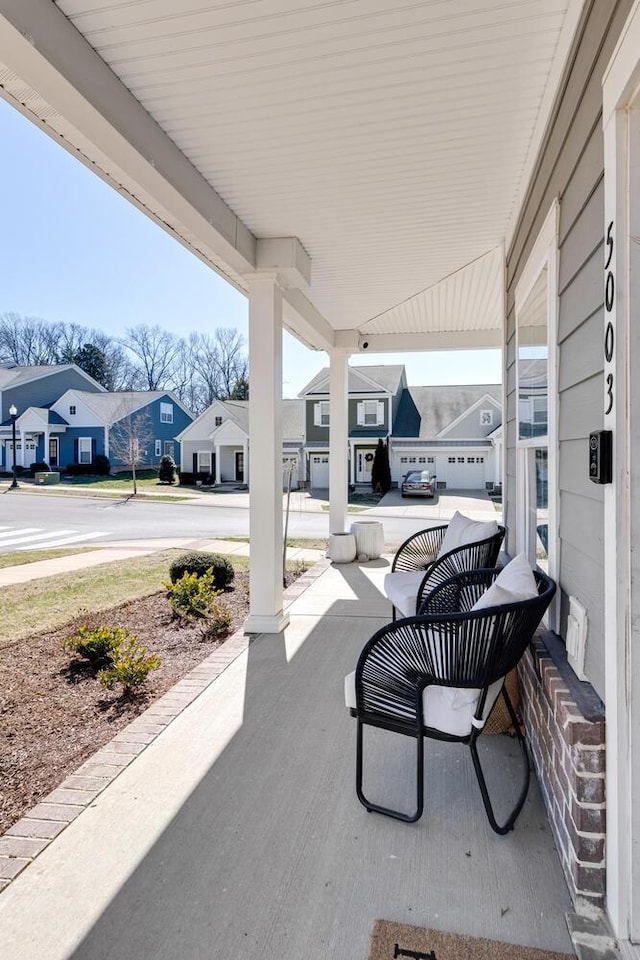 view of patio / terrace with covered porch and a residential view