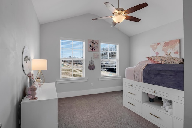 carpeted bedroom with a ceiling fan, vaulted ceiling, and baseboards