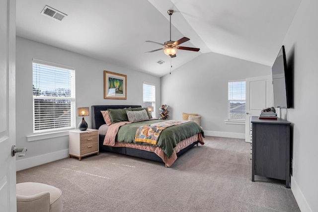 carpeted bedroom with baseboards, visible vents, vaulted ceiling, and a ceiling fan