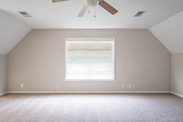 bonus room featuring carpet floors, visible vents, and vaulted ceiling