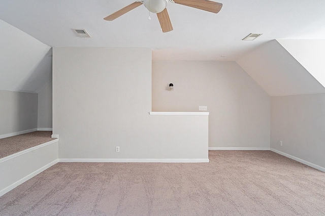 additional living space featuring vaulted ceiling, carpet, visible vents, and a ceiling fan