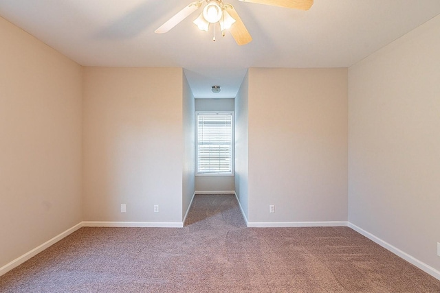 empty room featuring ceiling fan, carpet floors, and baseboards