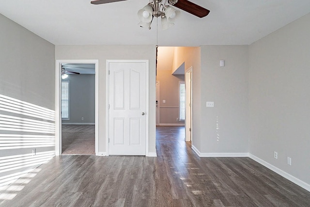 unfurnished room featuring a ceiling fan, baseboards, and wood finished floors