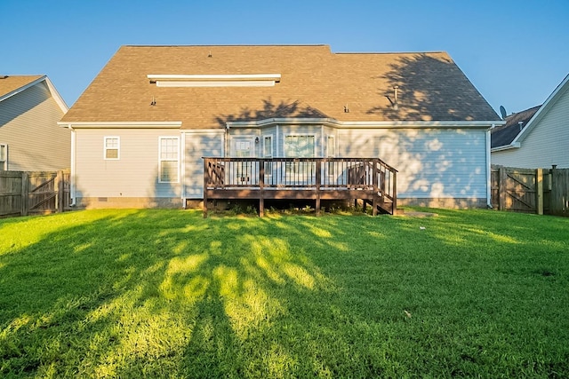 back of house featuring a yard, crawl space, a fenced backyard, and a gate