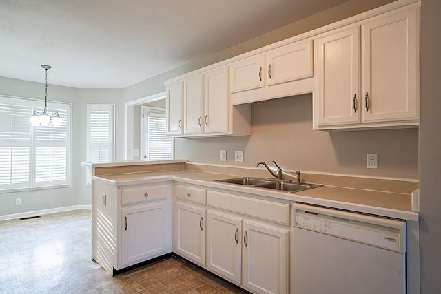 kitchen with a healthy amount of sunlight, dishwasher, decorative light fixtures, and a sink