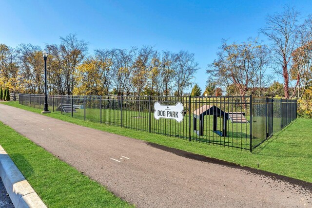 exterior space featuring fence and a lawn