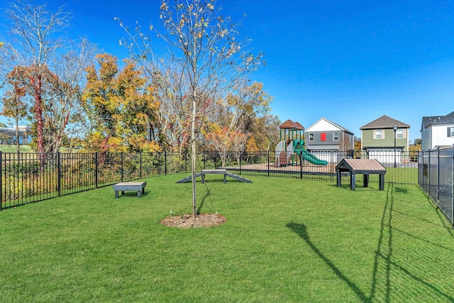 exterior space with a yard, playground community, and fence