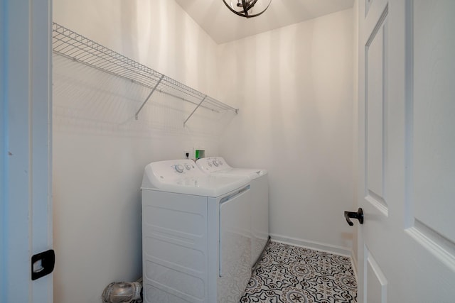 washroom with baseboards, laundry area, washer and clothes dryer, and tile patterned floors